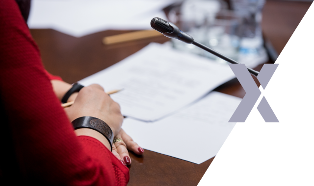 A committee member speaks into a microphone